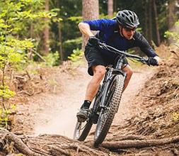 riding a mountain bike on dusty trails